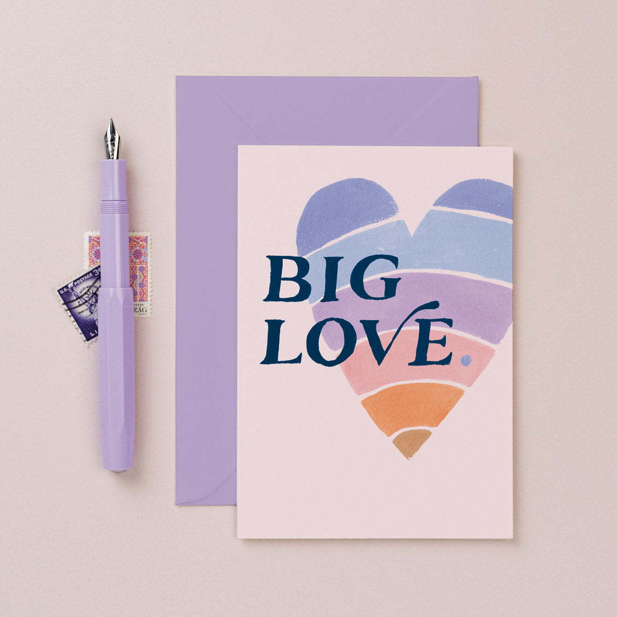 A rainbow heart with big love lettering on a love card from the wedding card collection at Sister Paper Co.