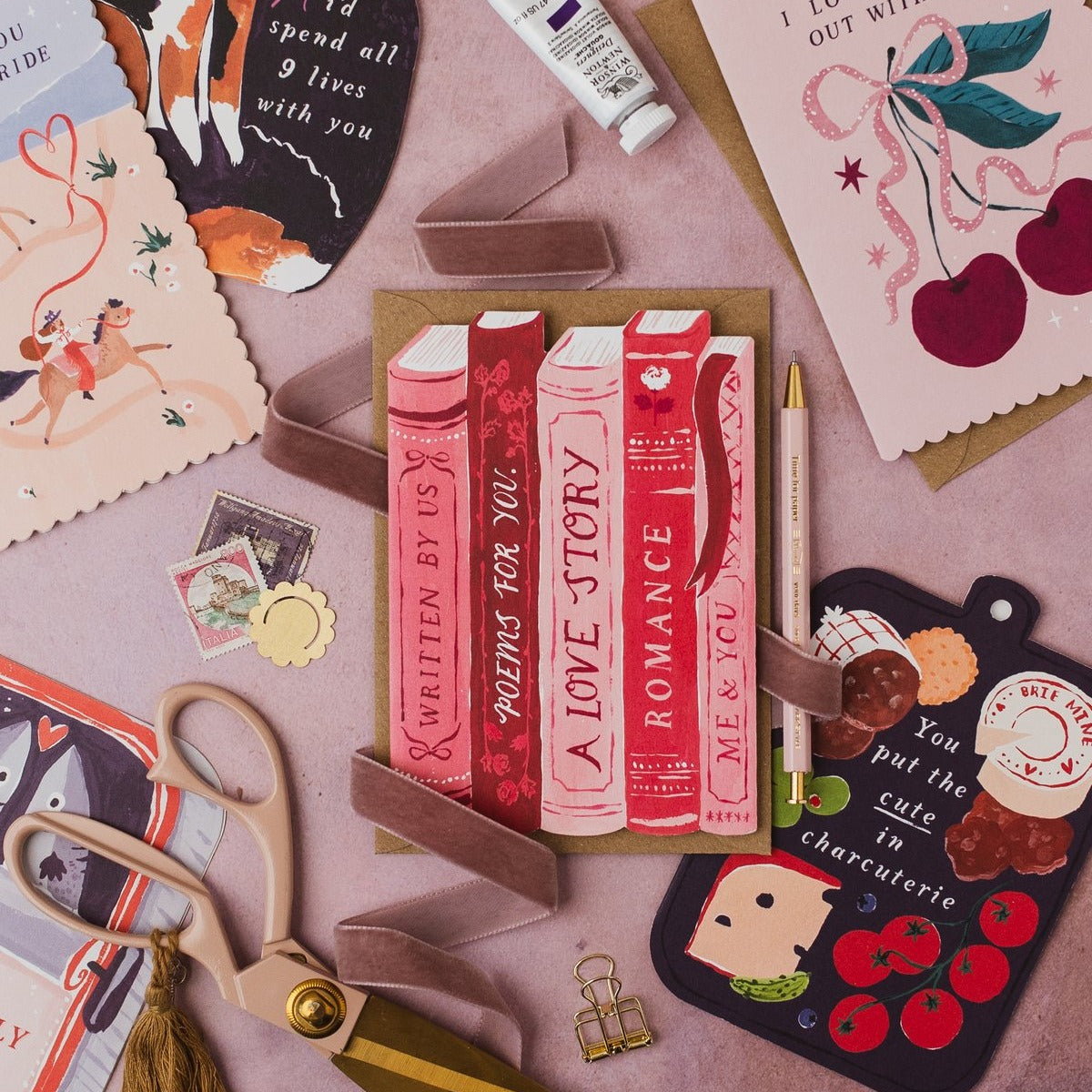 Book-stack love story card styled with props