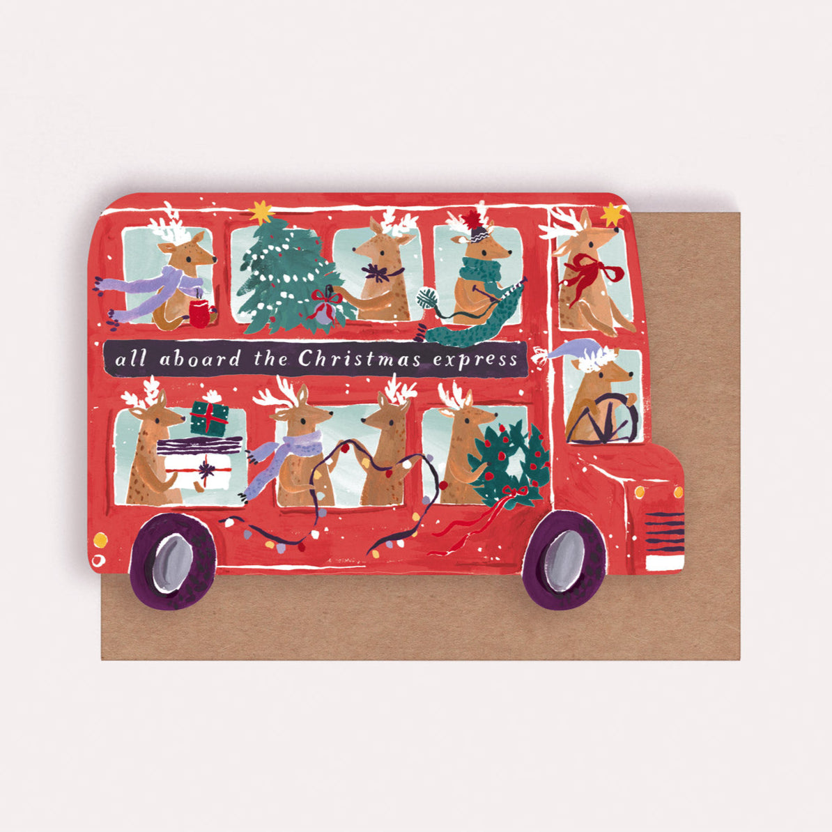 A Christmas card cut into the shape of bus full of reindeer from the Christmas card collection at Sister Paper Co.