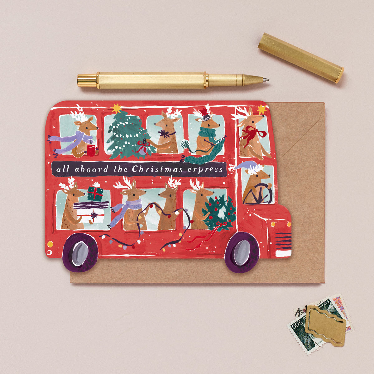 A Christmas card cut into the shape of bus full of reindeer from the Christmas card collection at Sister Paper Co.