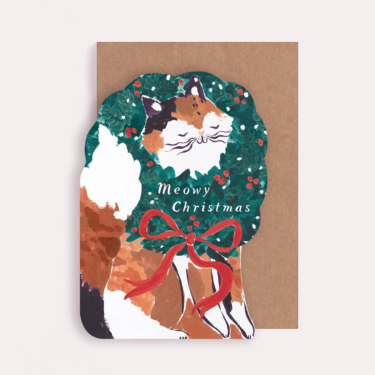 A Christmas card cut into the shape of a cat poking it's little face through a wreath from the Christmas card collection at Sister Paper Co.