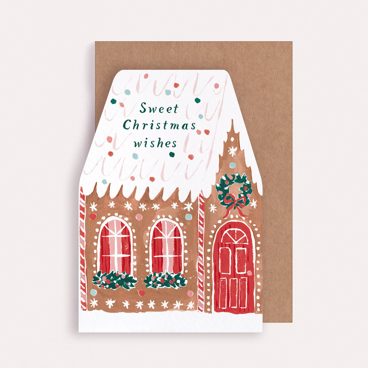 A Christmas card cut into the shape of a gingerbread house from the Christmas card collection at Sister Paper Co.