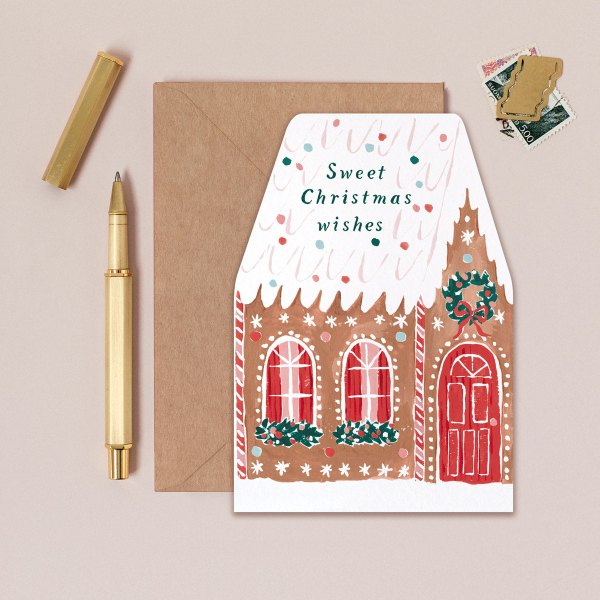 A Christmas card cut into the shape of a gingerbread house from the Christmas card collection at Sister Paper Co.