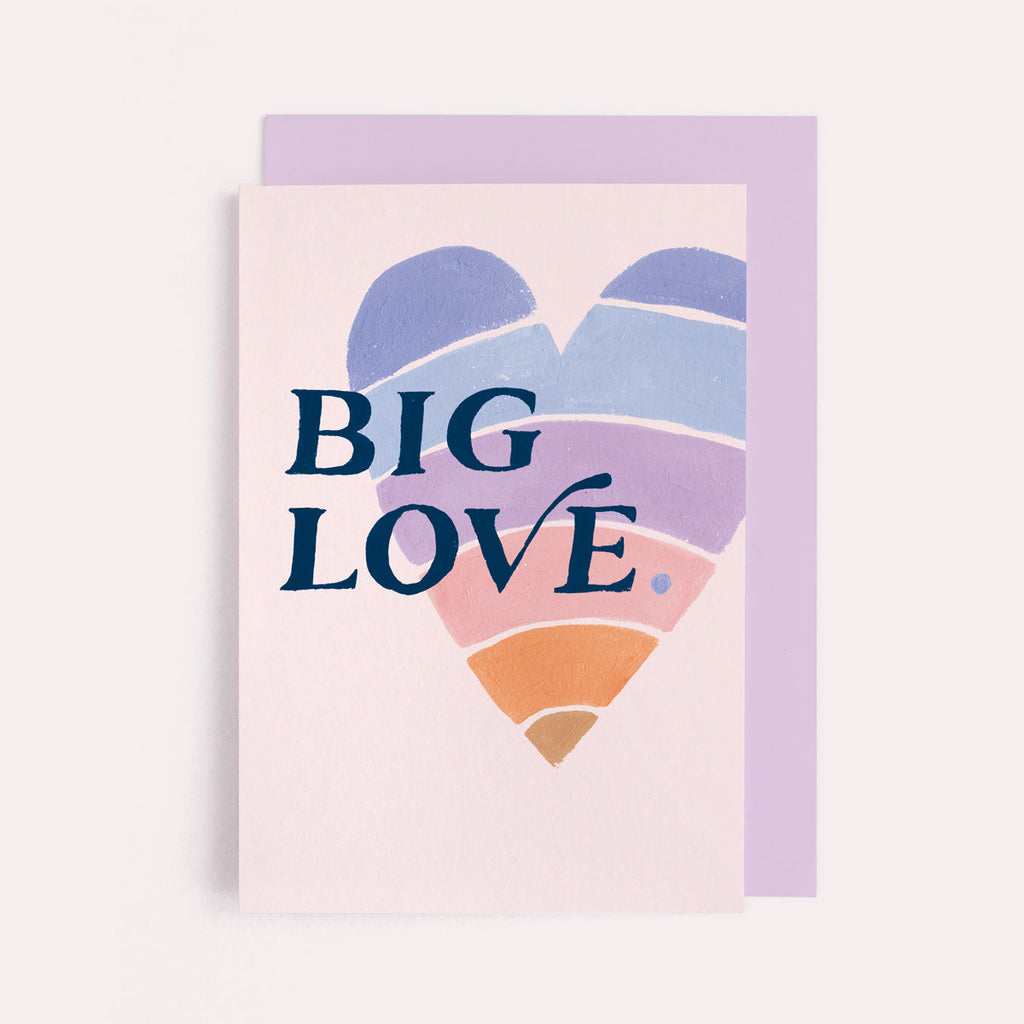 A rainbow heart with big love lettering on a love card from the wedding card collection at Sister Paper Co.