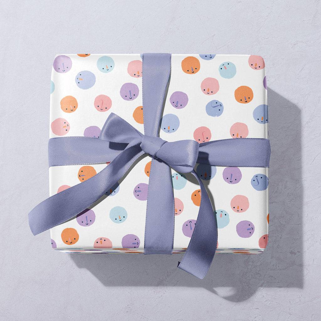 A cute smiley faces pattern on wrapping paper from the birthday wrapping paper collection at Sister Paper Co.