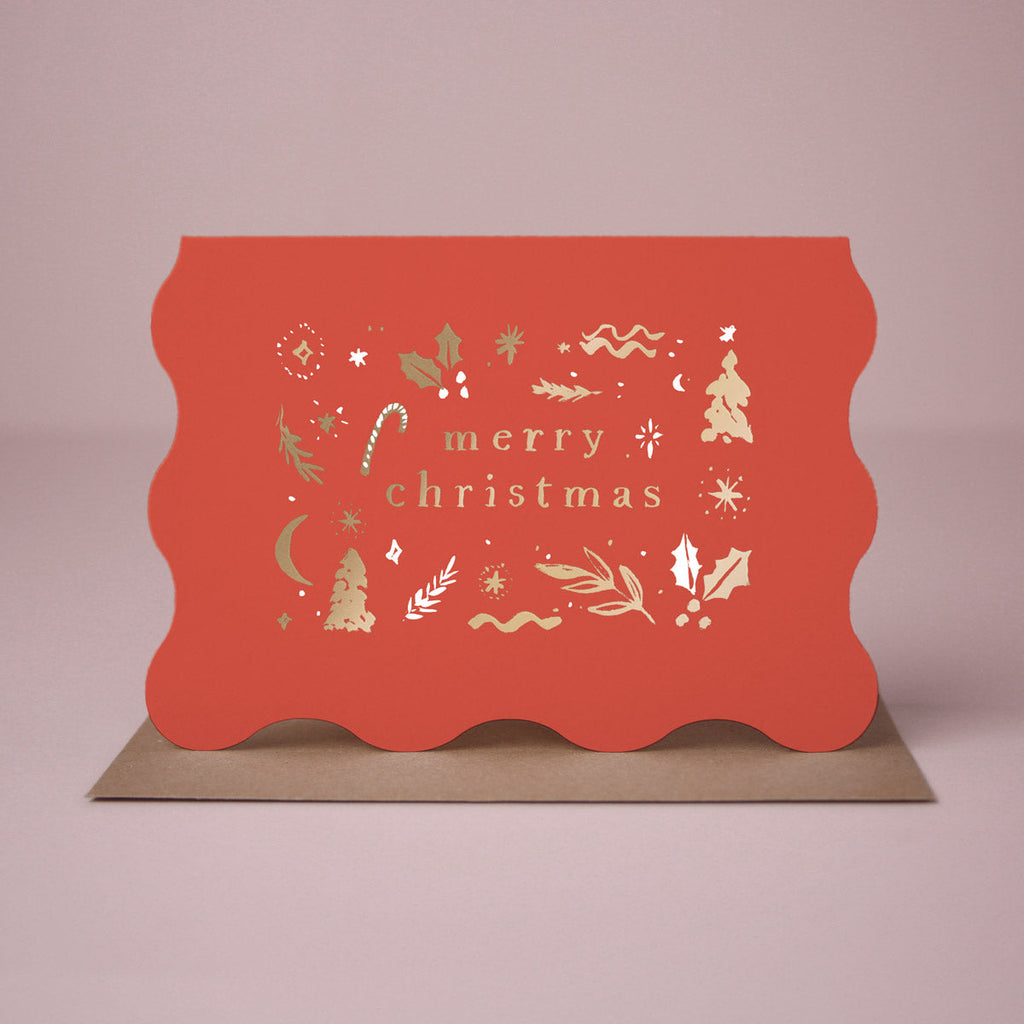A red wavy edge Christmas card with sparkly gold foil details from the Sister Paper Co. collection of Christmas cards.