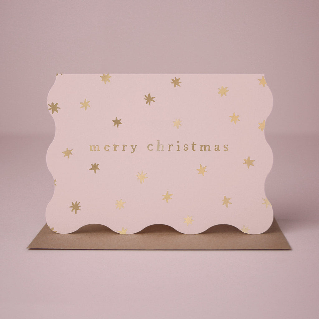 A wavy edge Christmas card with sparkly gold foil stars from the Sister Paper Co. collection of Christmas cards.