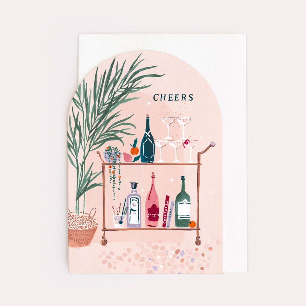 A birthday card with cheers lettering and bar cart with gin illustration on a birthday card from the female birthday card collection at Sister Paper Co.