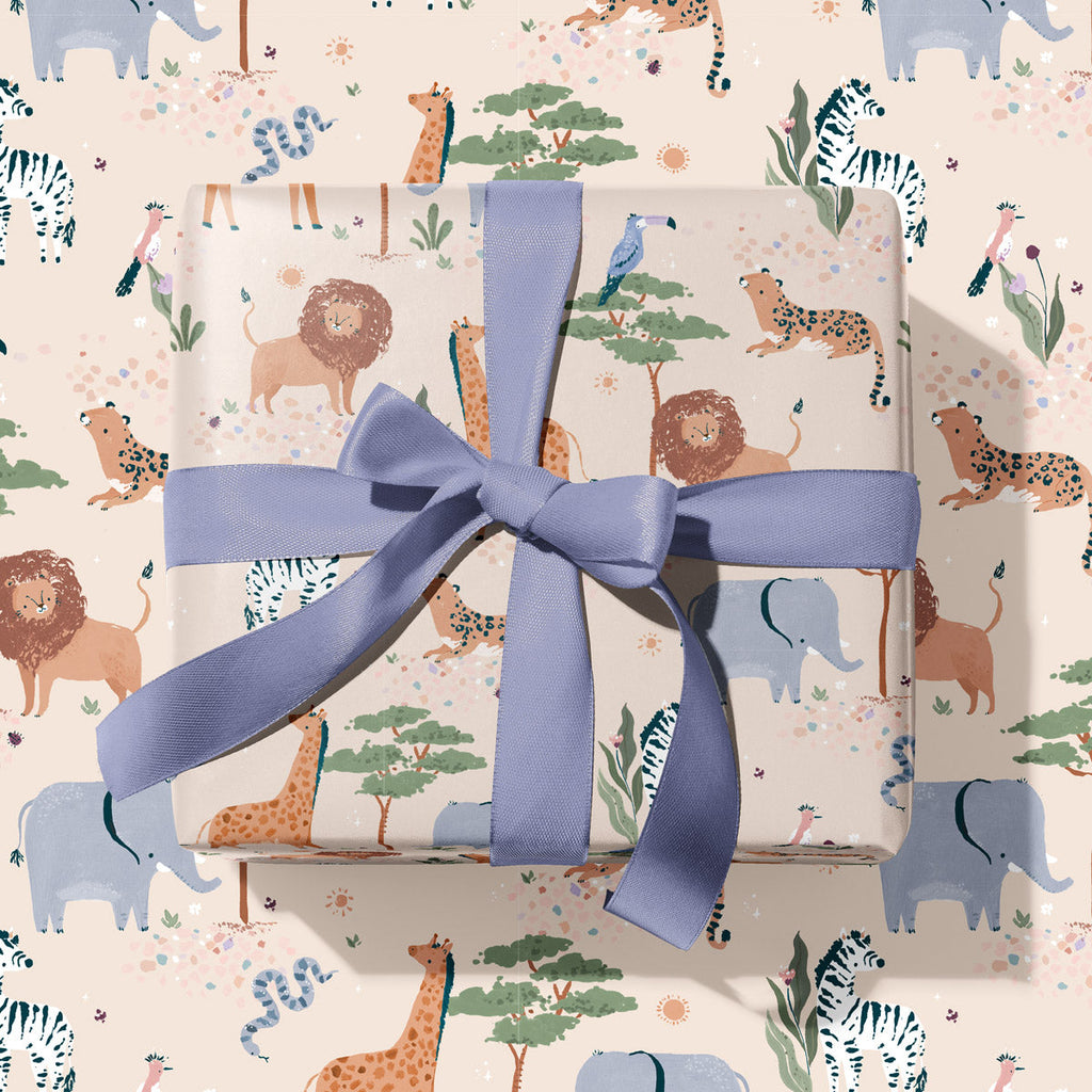A wrapped gift box with safari animal print wrapping paper from the Kids gift wrap collection at Sister Paper Co.