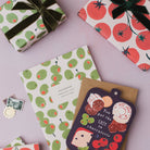 Olives gift wrap styled with a wrapped gift and ribbon