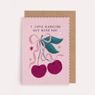 Scallop-edged cherry anniversary and Valentine's card with a pink bow and the caption 'I Love Hanging Out With You'