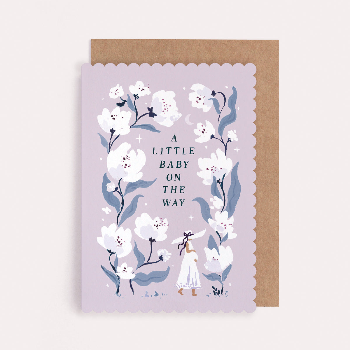 Scallop-edged pregnancy and new baby card with a mum-to-be among white flowers and the caption 'A Little Baby On The Way'