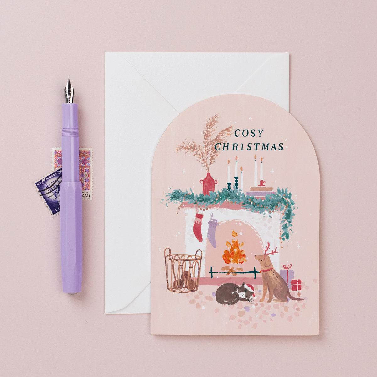 A christmas card featuring a cosy fireplace, dog and cat from the Nevada holiday card collection at Sister Paper Co.