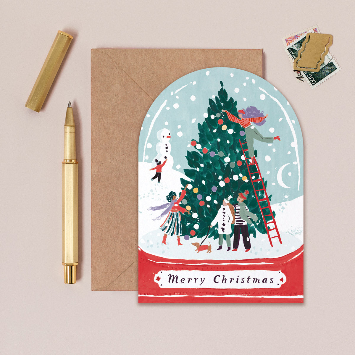 A Christmas card cut into the shape of a snow globe from the Christmas card collection at Sister Paper Co.