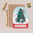 A Christmas card cut into the shape of a snow globe from the Christmas card collection at Sister Paper Co.