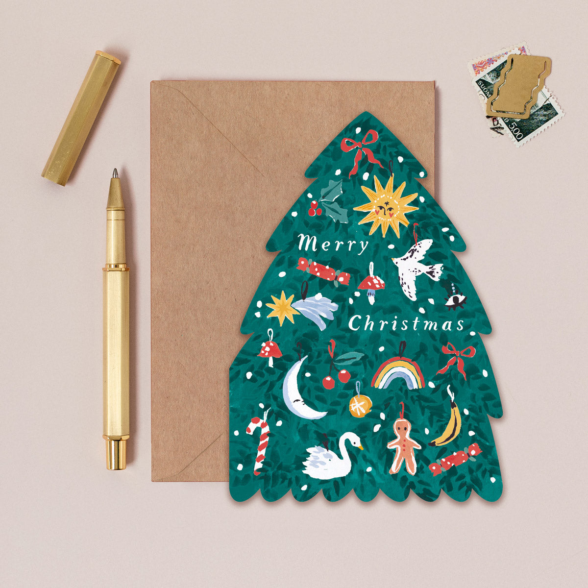 A Christmas card cut into the shape of a Christmas tree from the Christmas card collection at Sister Paper Co.