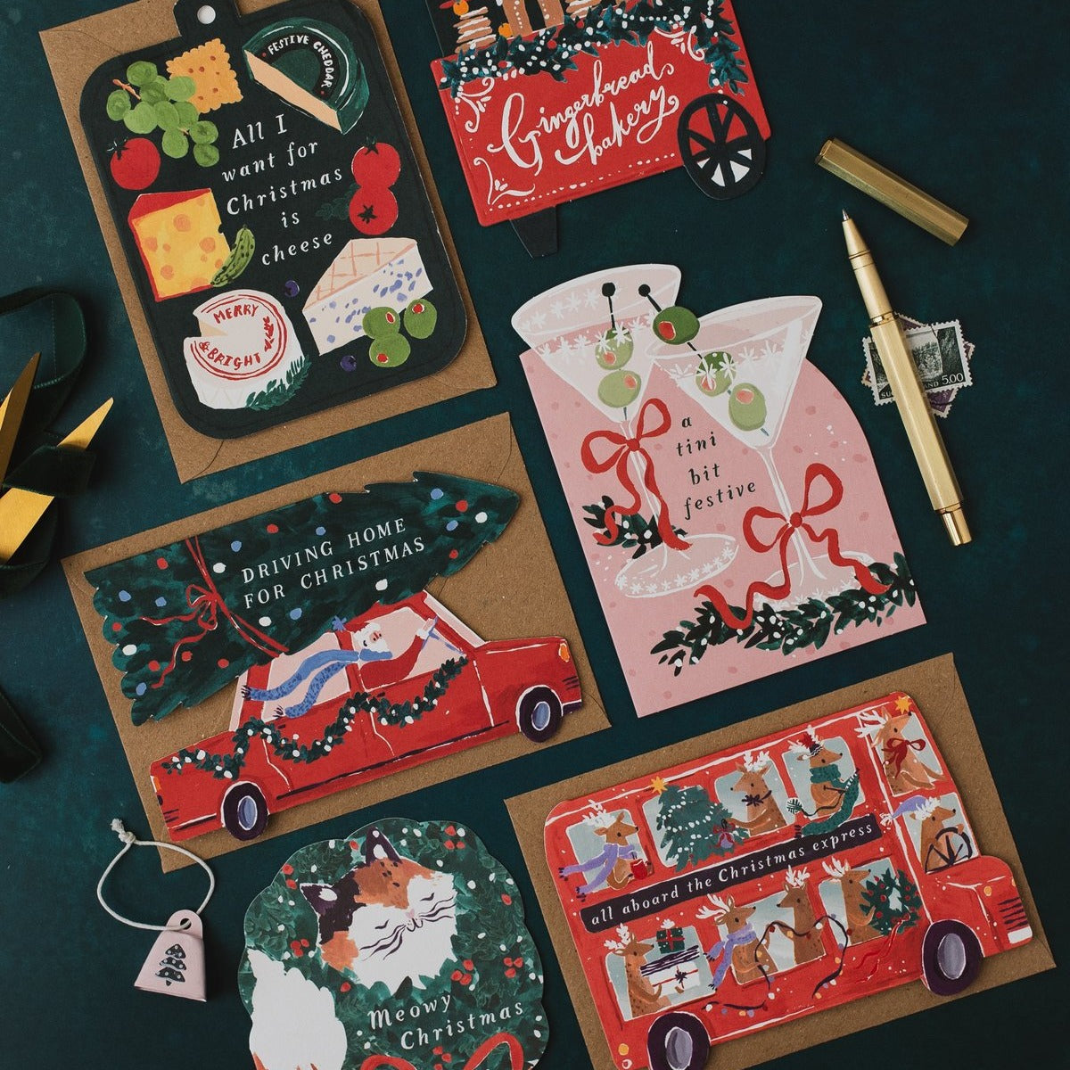 Driving Home for Christmas car shaped card on a dark teal background with cheeseboard, martini and Christmas bus cards
