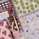Croissant Cafe notebook styled in a flat lay