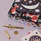 Sleeping moon pocket notebook styled in a flat lay