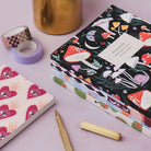 Sacred heart pocket notebook styled in a flat lay