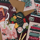 Cheeseboard shaped Christmas card with martini, mulled wine and Bookish Christmas cards on a deep red background