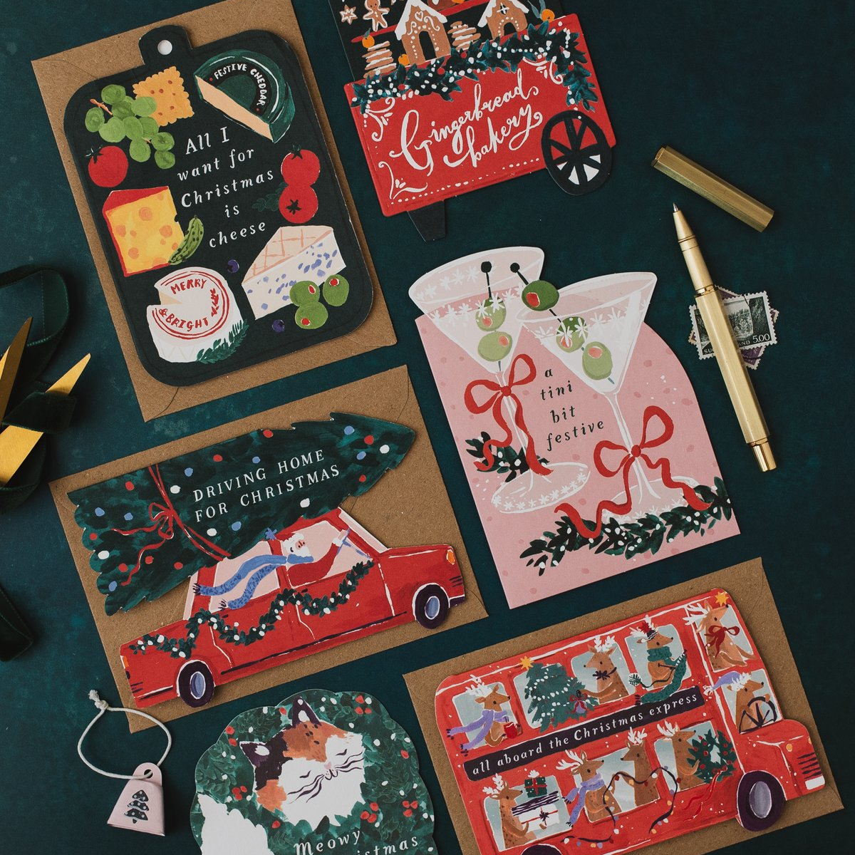 Tini Bit Festive martini Christmas card on a dark teal background with cheeseboard, gingerbread cart, Driving Home for Christmas and Christmas bus cards
