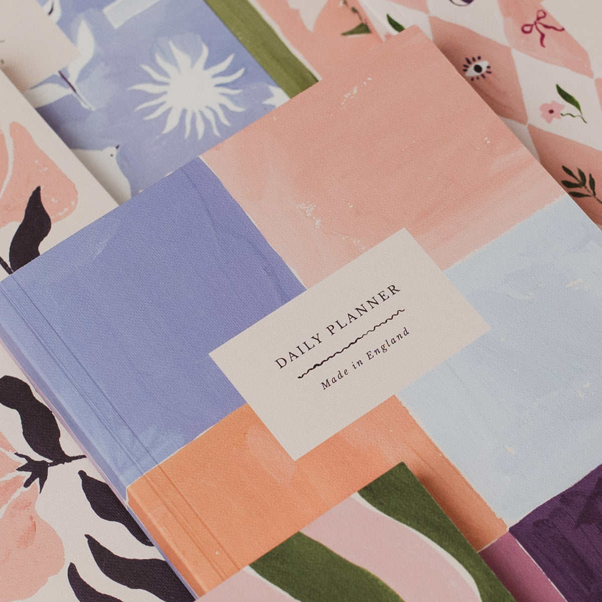 Collection of colorful planners with various designs and a 'Daily Planner' label.