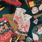 Tini Bit Festive martini Christmas card on a dark teal background with gingerbread cart, cheeseboard and Driving Home for Christmas cards
