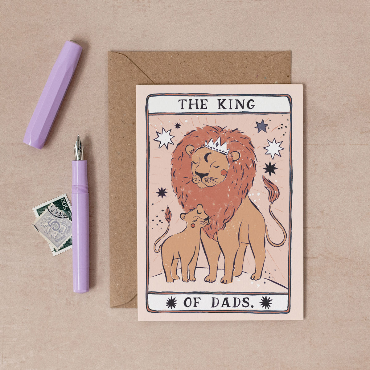 The King Of Dads card from the Tarot collection at Sister Paper Co features a king lion and his cub.