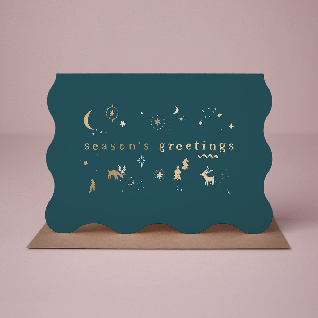 A wavy edge Christmas card with sparkly gold foil icons from the Sister Paper Co. collection of Christmas cards.