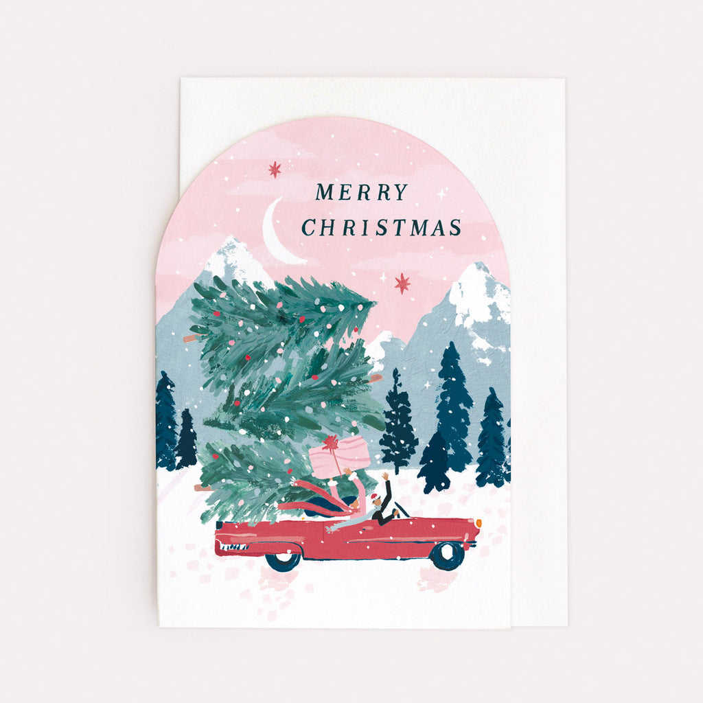 A Christmas card featuring a convertible car stacked with Christmas trees from the Nevada holiday card collection at Sister Paper Co.