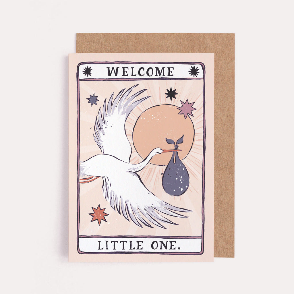 A gender neutral baby card with illustrated stork and welcome little one hand lettering on a new baby card from the unisex baby collection at Sister Paper Co.
