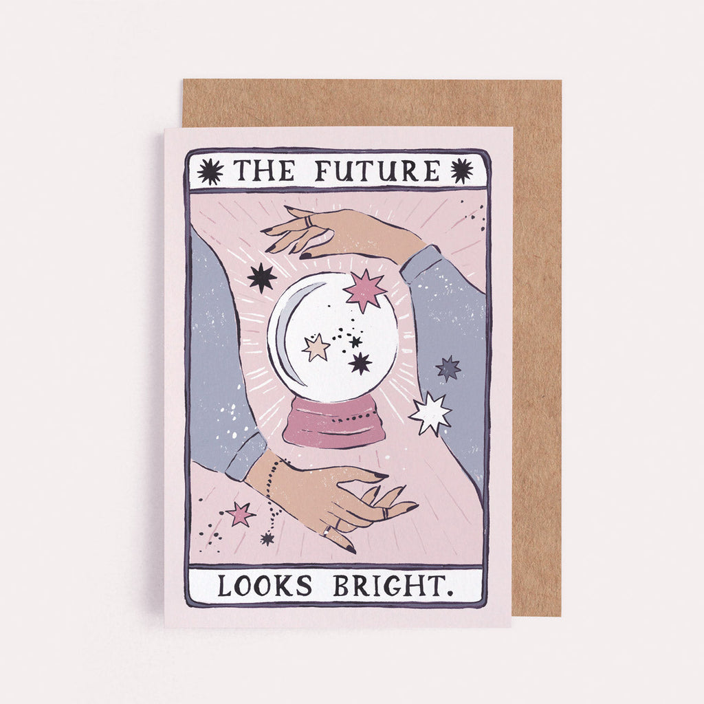 The Future Looks Bright card from the Tarot collection at Sister Paper Co features a fortune teller's hands, crystal ball and stars..