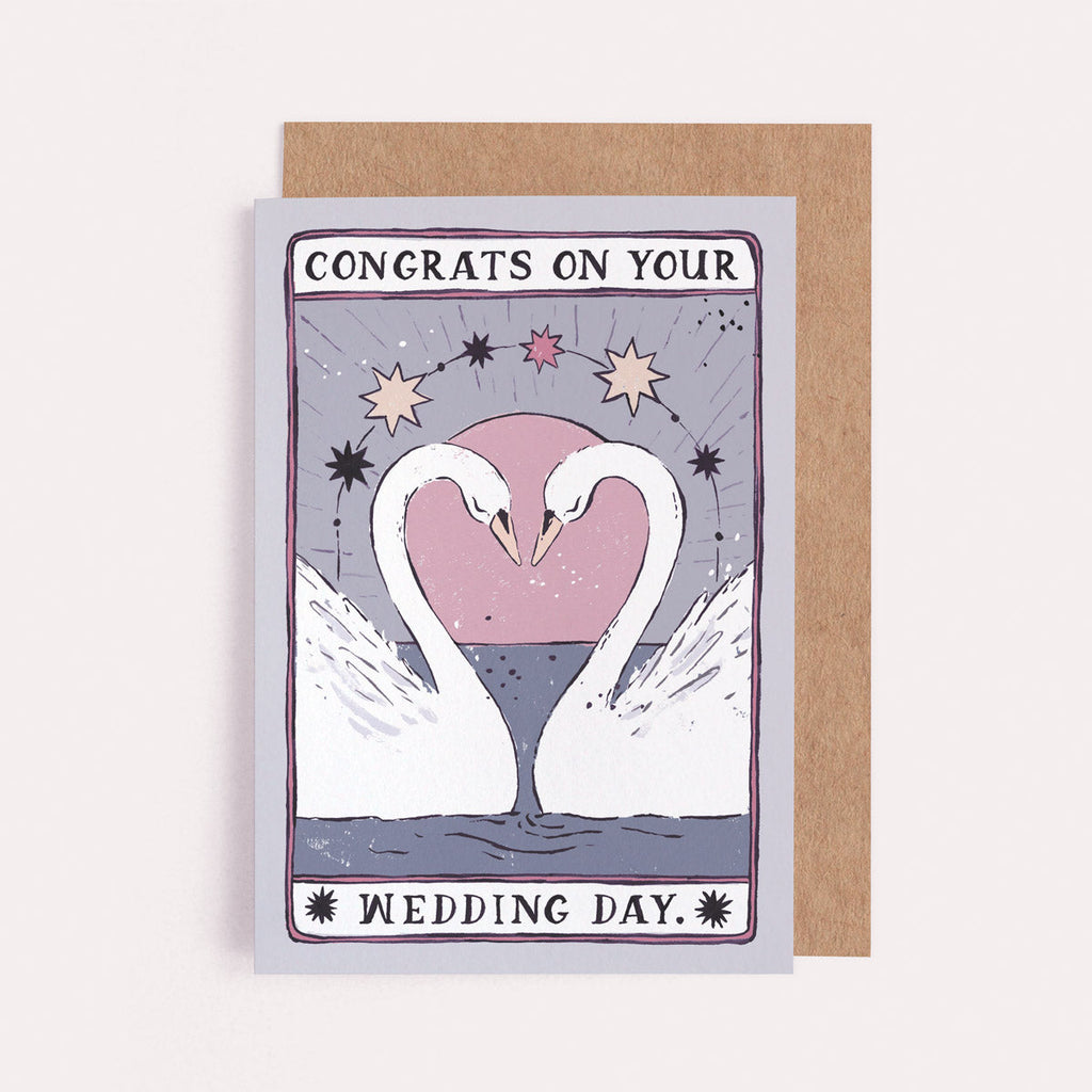 The Congrats on Your Wedding Day Swan card from the Tarot collection at Sister Paper Co features two swans in a heart shape.