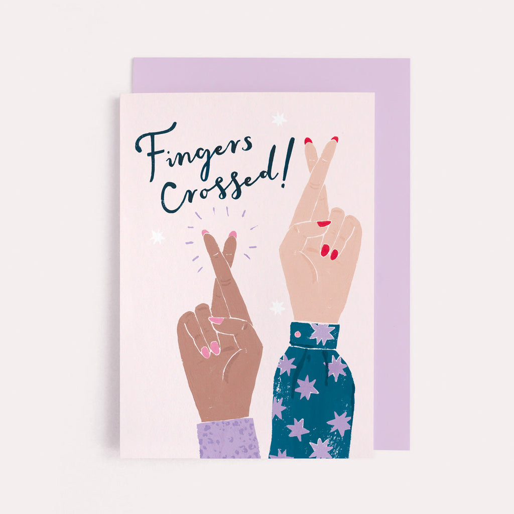 A pair of fingers crossed on a good luck card from the card collection at Sister Paper Co.